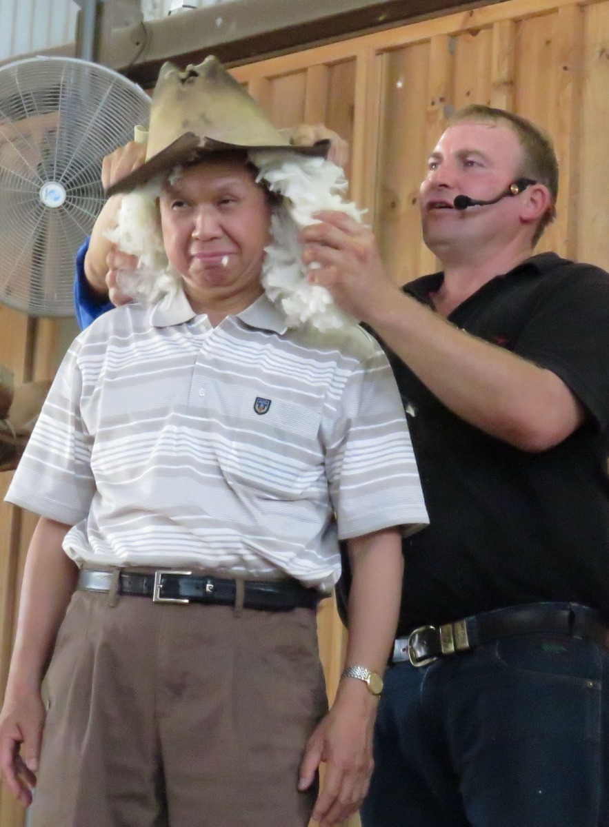 師傅拿羊毛團放在遊客頭上戴帽子扮牛仔。高維奇/攝