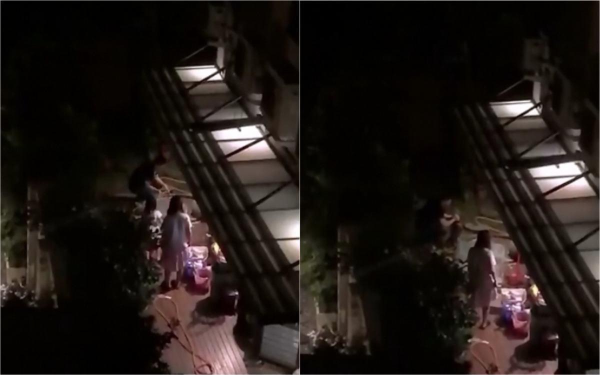 屋主在兩名小孩面前用水管打狗。動保志工/提供